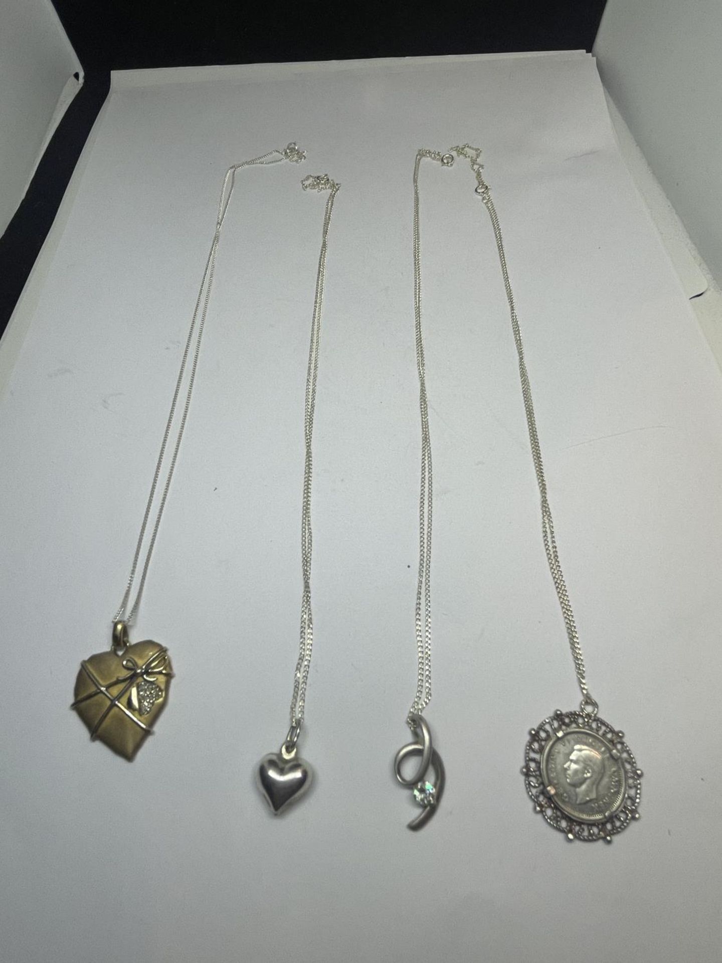 FOUR SILVER NECKLACES WITH PENDANTS