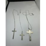 THREE SILVER NECKLACES WITH CROSS PENDANTS