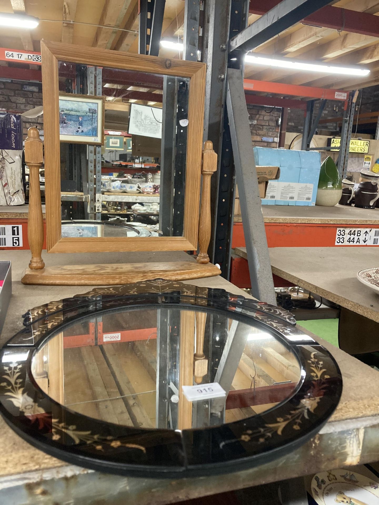 A PINE FRAMED DRESSING TABLE MIRROR AND A BLACK GLASS MIRROR WITH AN ORNATE TOP