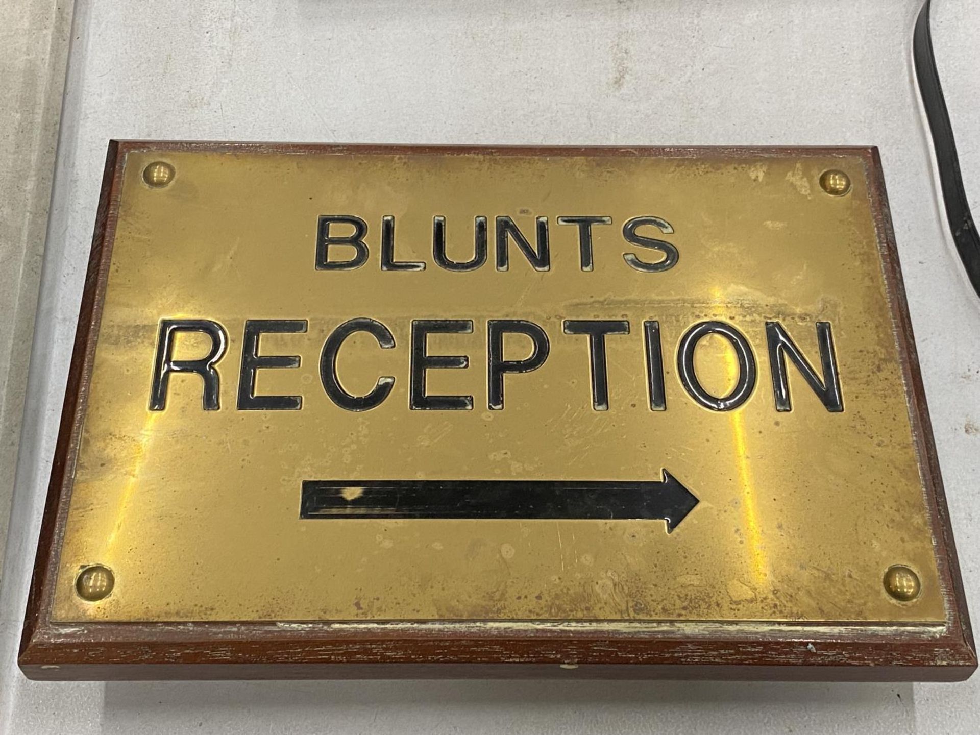 A VINTAGE WOOD AND BRASS 'BLUNTS RECEPTION' SIGN 33CM X 23CM