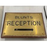 A VINTAGE WOOD AND BRASS 'BLUNTS RECEPTION' SIGN 33CM X 23CM