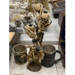 A RESIN SKELETON CANDLESTICK HEIGHT 34CM, A SKELETON BRIDE AND GROOM AND TWO TANKARDS