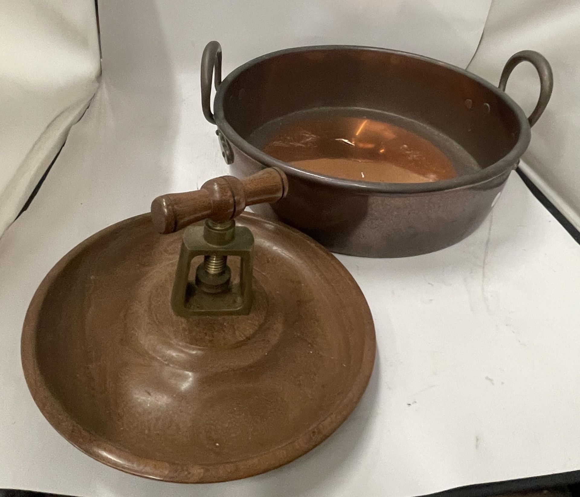 A VINTAGE TWIN HANDLED COPPER BOWL WITH TREEN NUTCRACKER BOWL