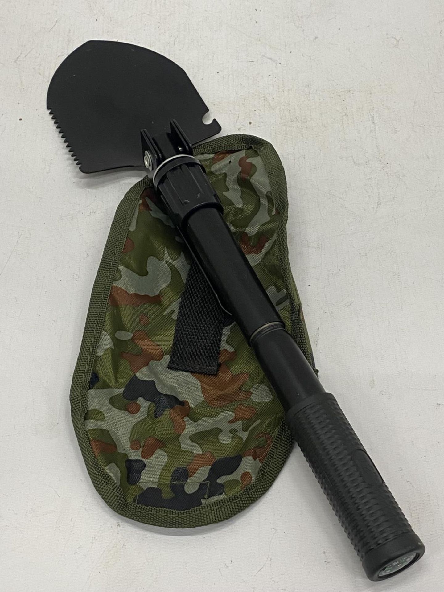 A MILITARY STYLE TRENCH SHOVEL IN A CASE