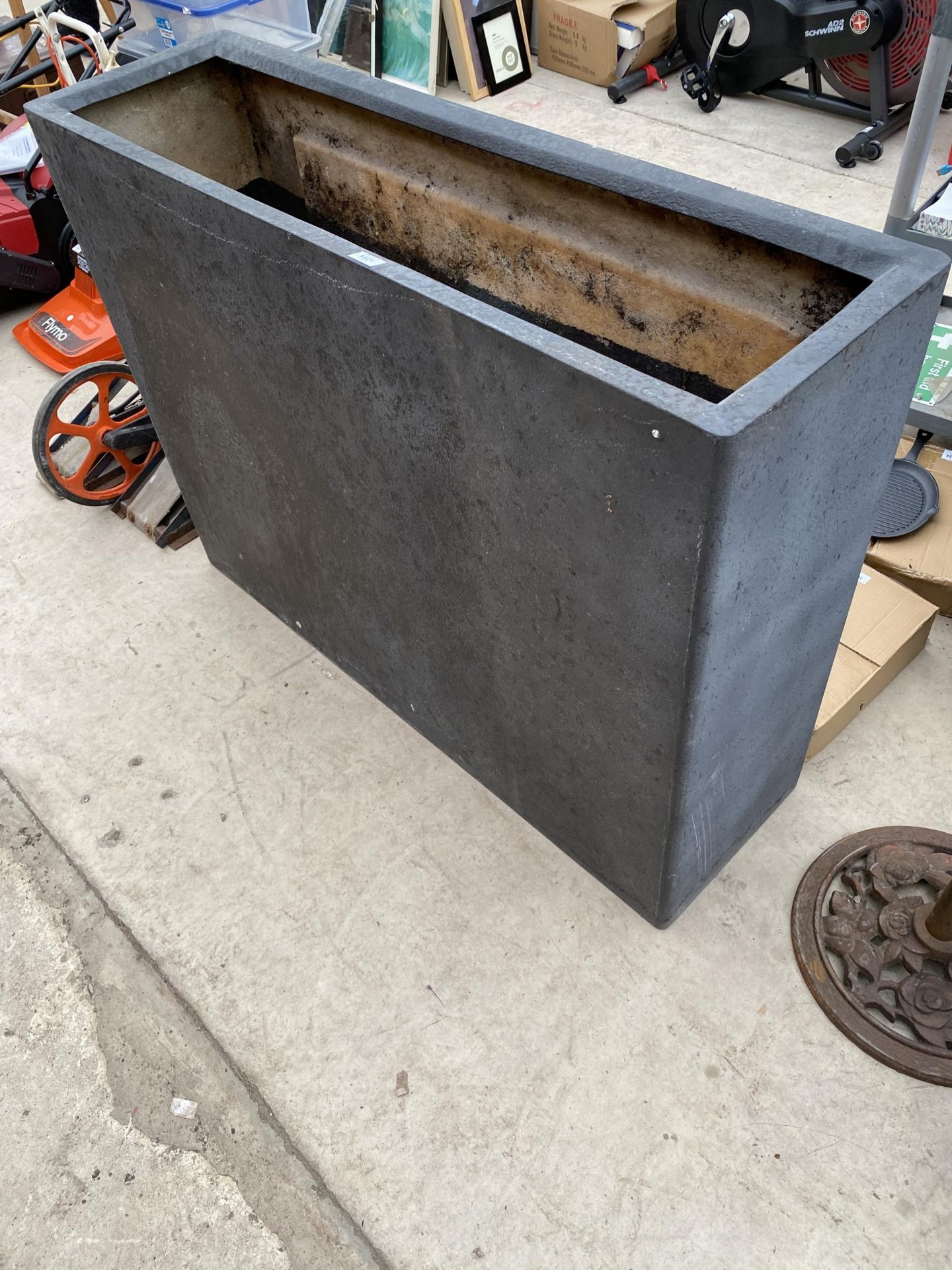 A TALL BLACK FIBRE GLASS TROUGH PLANTER (H:90CM L:120CM D:35CM)