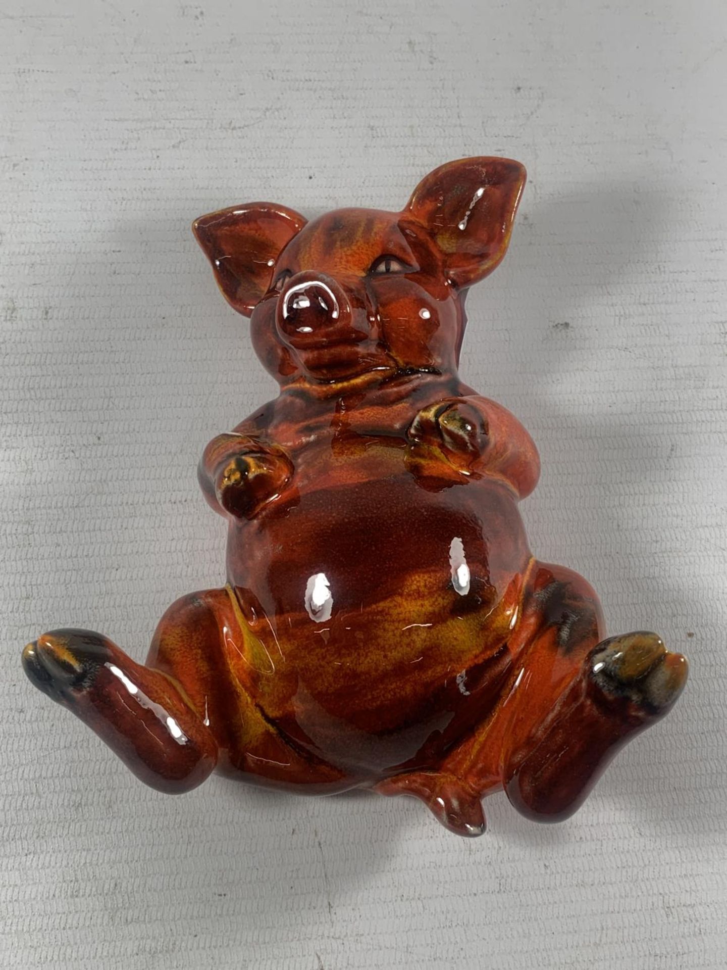 AN ANITA HARRIS HAND PAINTED AND SIGNED IN GOLD LYING DOWN PIG