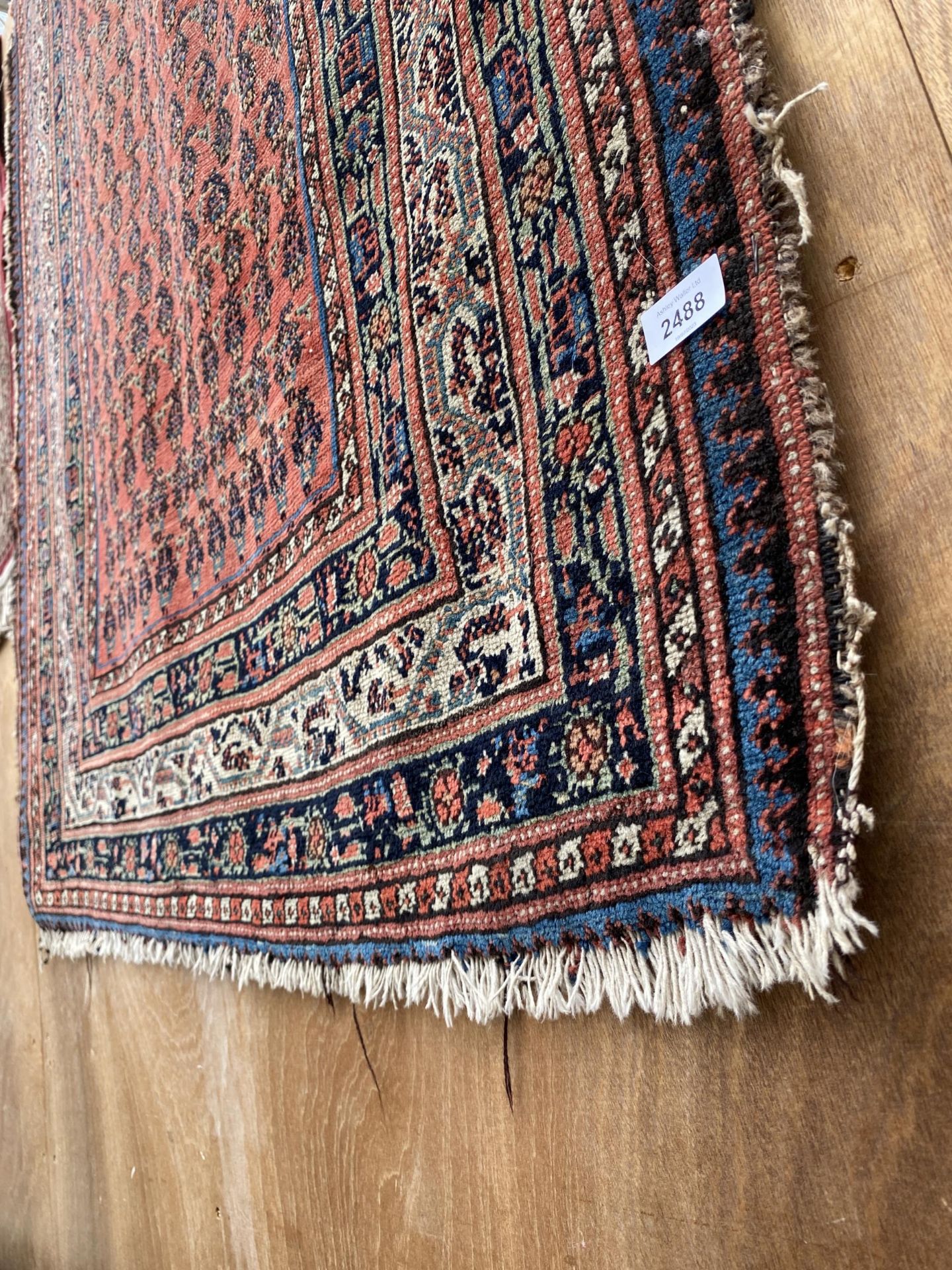 A LARGE RED AND BLUE PATTERNED RUG - Image 2 of 2