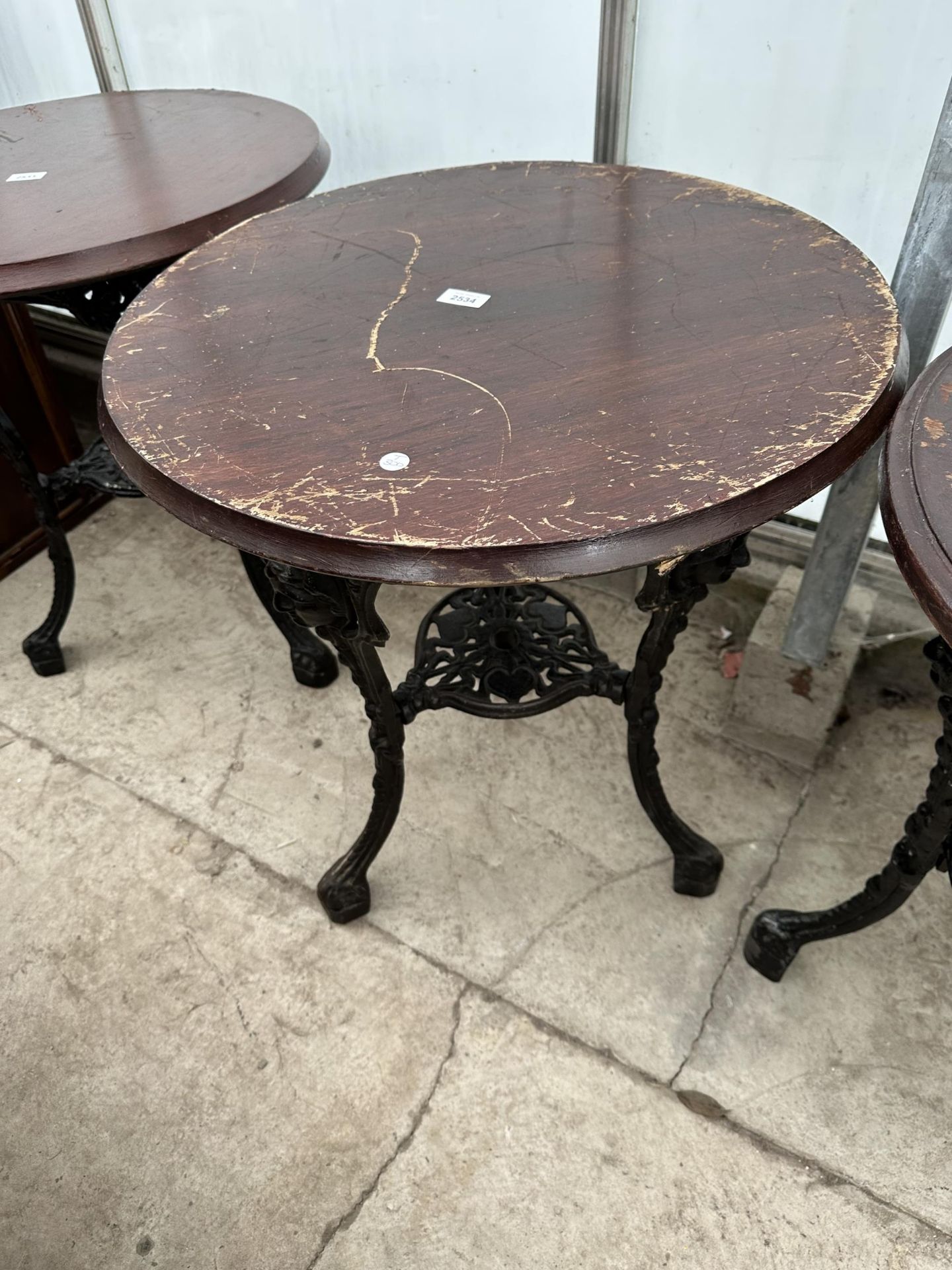 A 24.5" DIAMETER PUB TABLE ON A HEAVY CAST IRON BASE