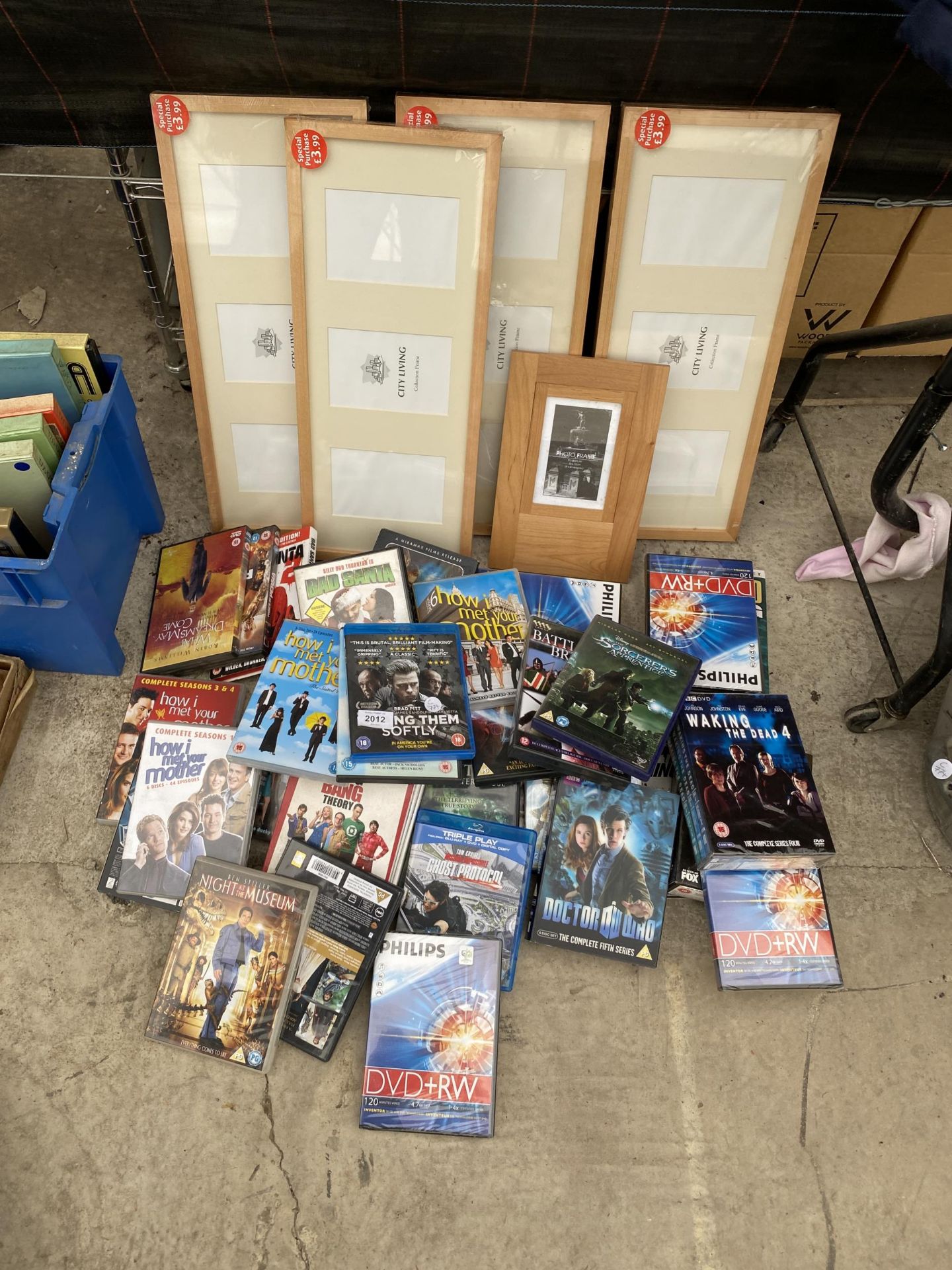 AN ASSORTMENT OF DVDS AND PICTURE FRAMES