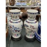 A PAIR OF ORIENTAL VASES 'THE DANCE OF THE CELESTIAL DRAGON' HEIGHT 27CM WITH WOODEN BASES