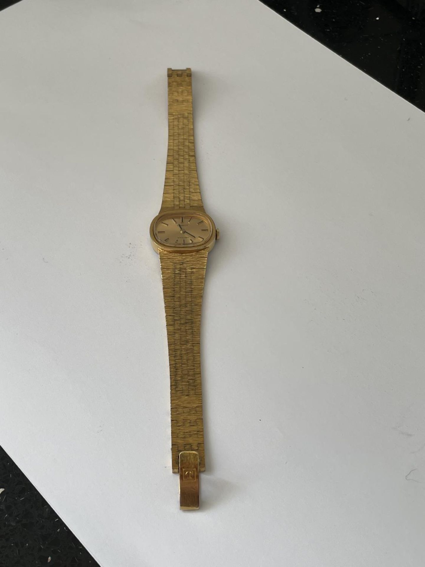 A TISSOT WRISTWATCH WITH YELLOW METAL STRAP SEEN WORKING BUT NO WARRANTY