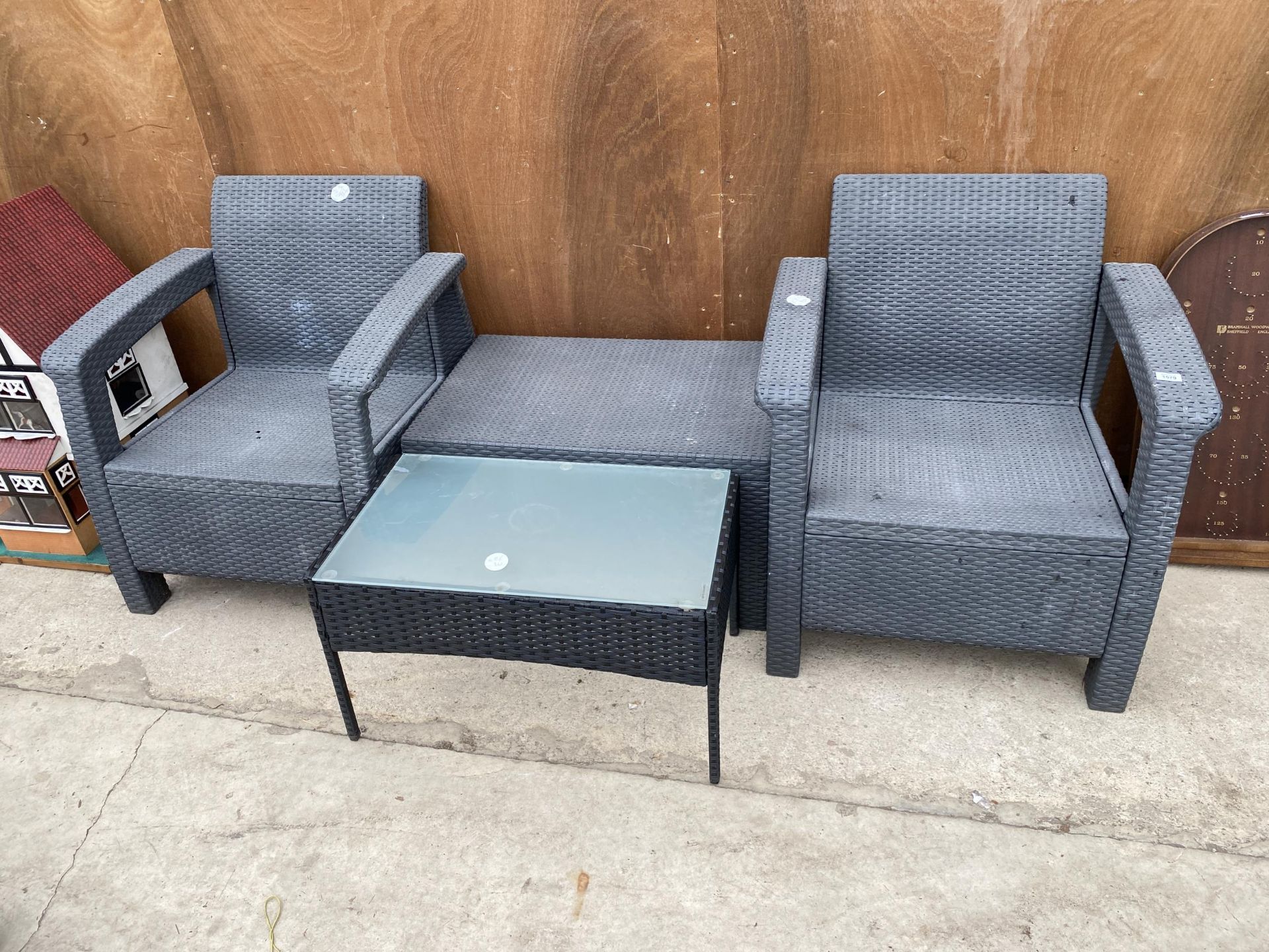 A RATTEN GARDEN SET COMPRISING OF TWO ARMCHAIRS AND TWO TABLES