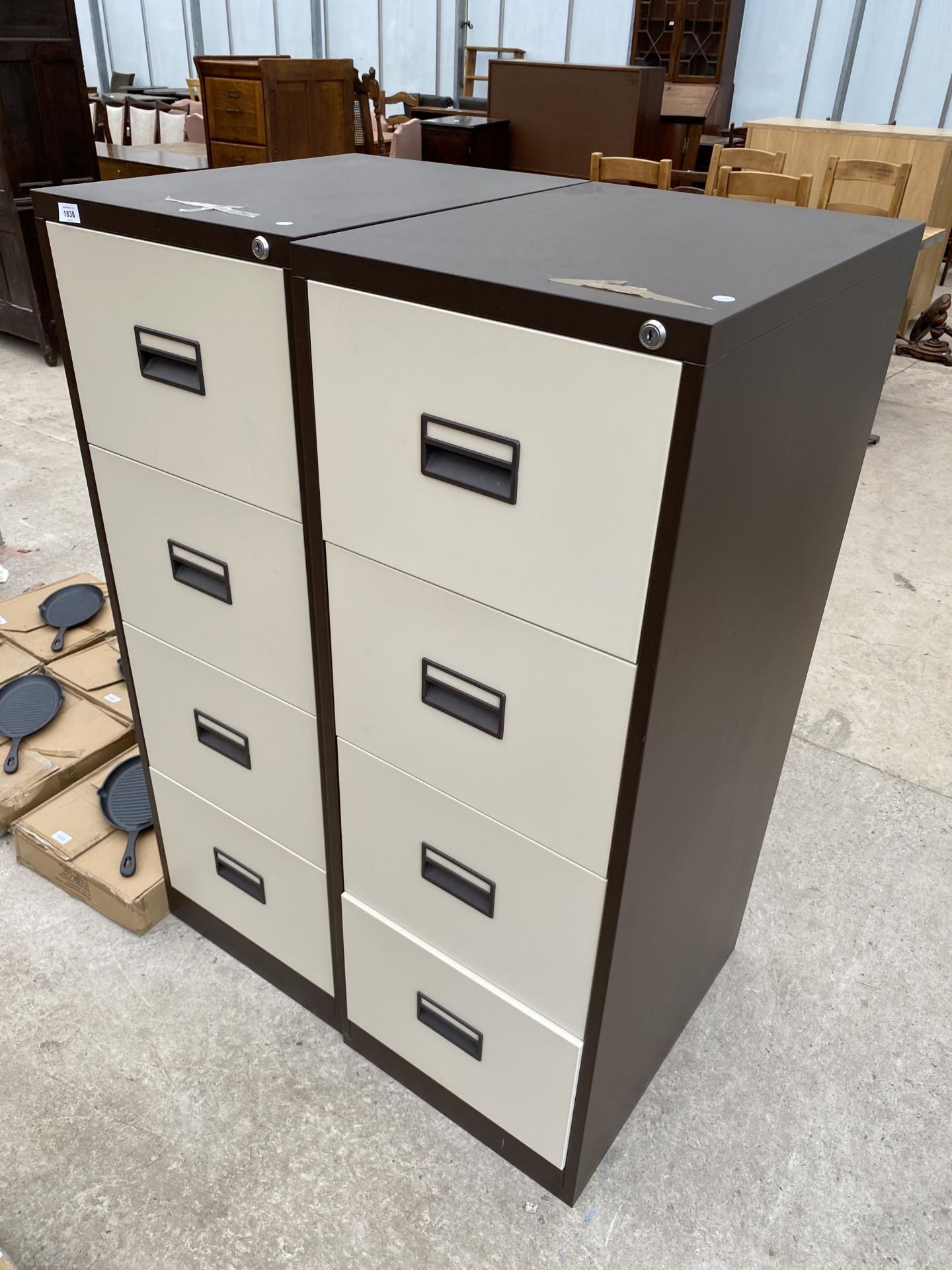 A PAIR OF FOUR DRAWER METAL FILING CABINETS