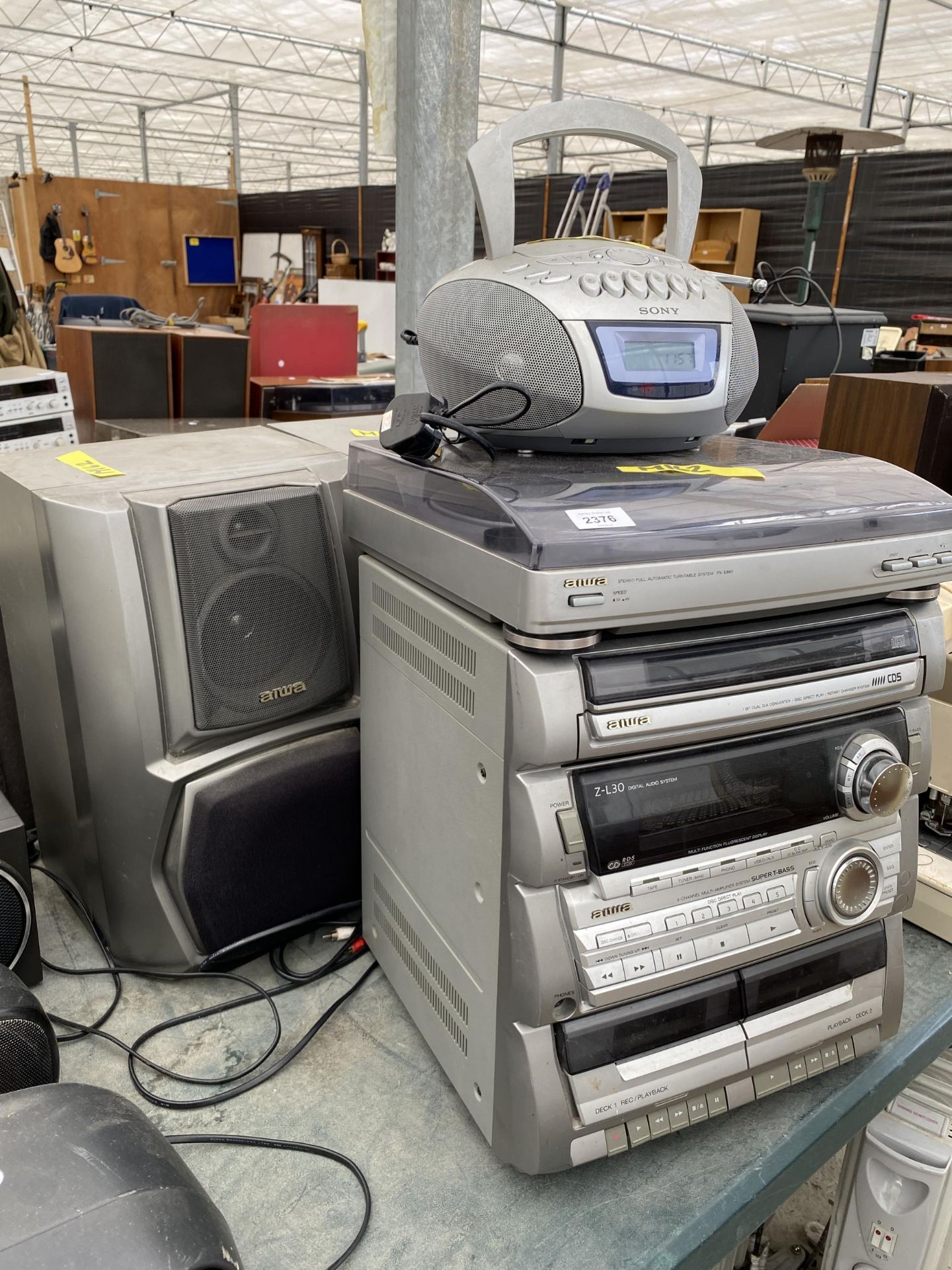 AN AIWA STEREO SYSTEM WITH A PAIR OF SPEAKERS AND A SONY CD/RADIO