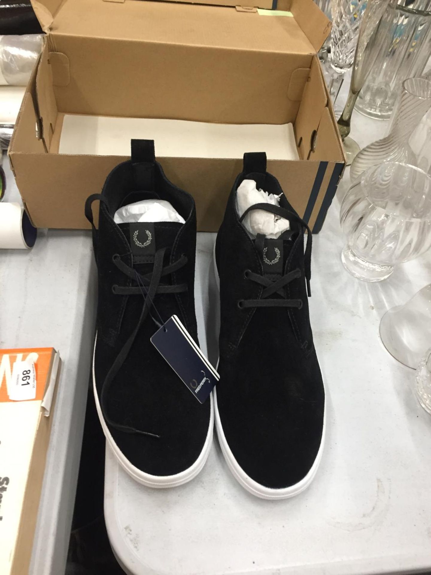 AN UNWORN BOXED PAIR OF FRED PERRY BLACK SUEDE TRAINERS
