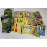 THREE TINS OF ASSORTED POKEMON TRADING CARDS, HOLOS ETC