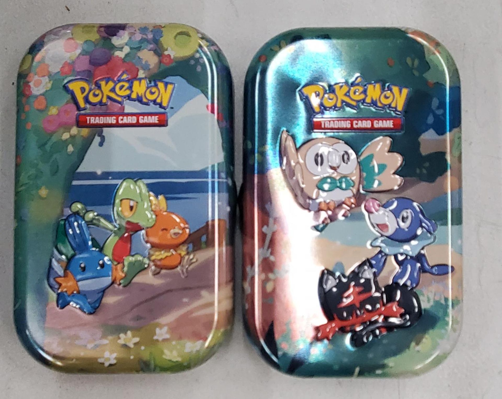 TWO TINS OF POKEMON CARDS INCLUDING HOLOS, ETC - 100+