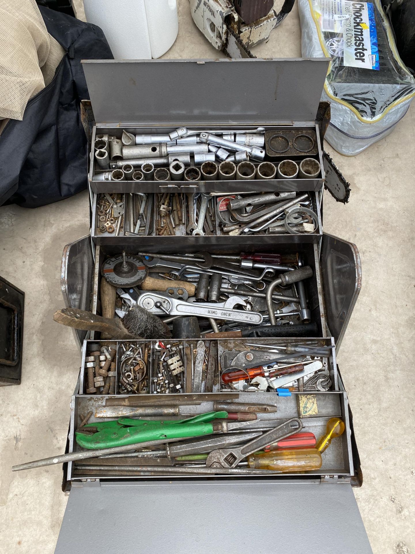 A METAL TOOL BOX WITH AN ASSORTMENT OF TOOLS TO INCLUDE SPANNERS, ALAN KEYS AND A WIRE BRUSH ETC