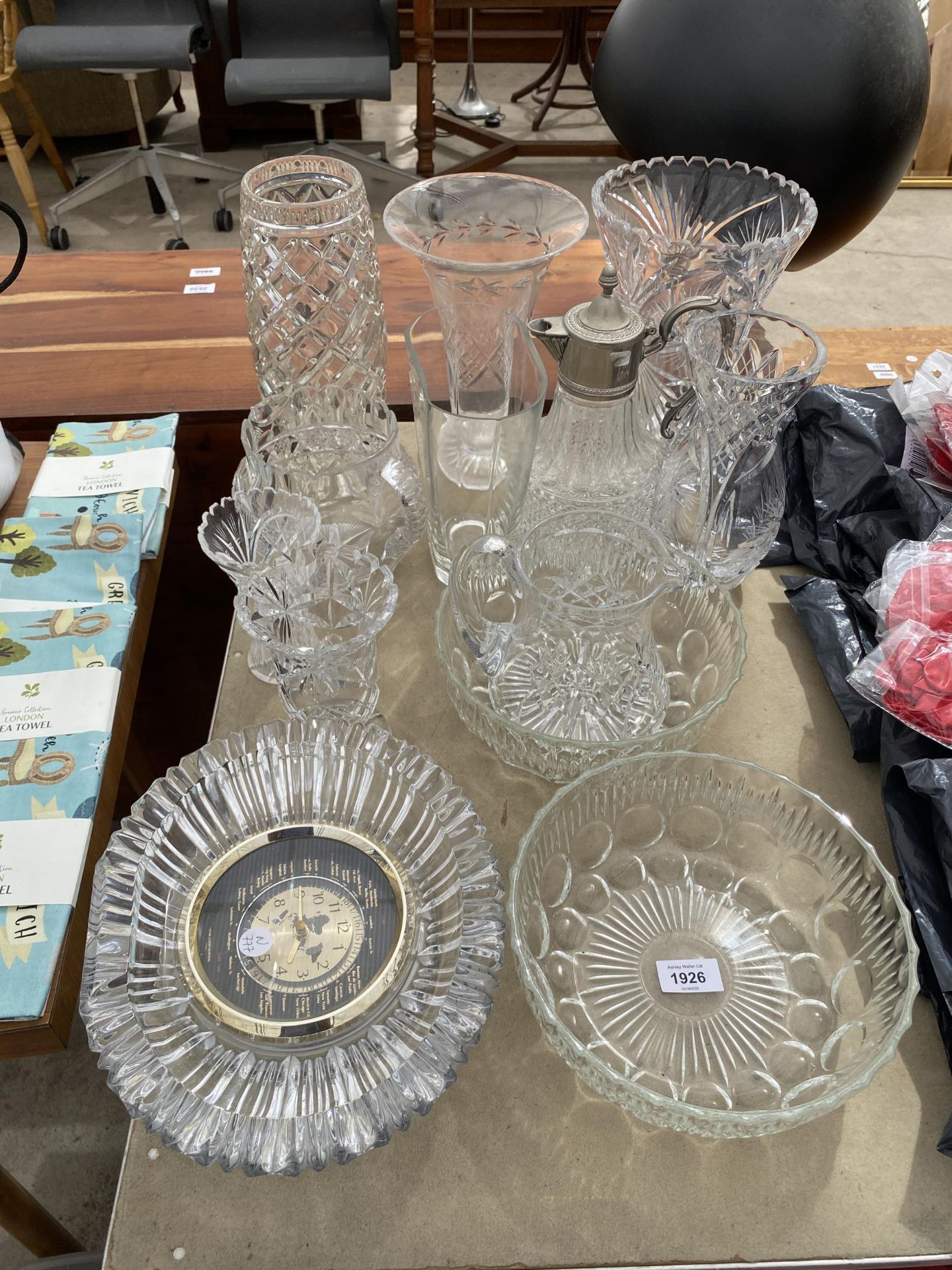 AN ASSORTMENT OF CUT GLASS WARE TO INCLUDE A WORLD CLOCK, A CLARET JUG AND VASES ETC