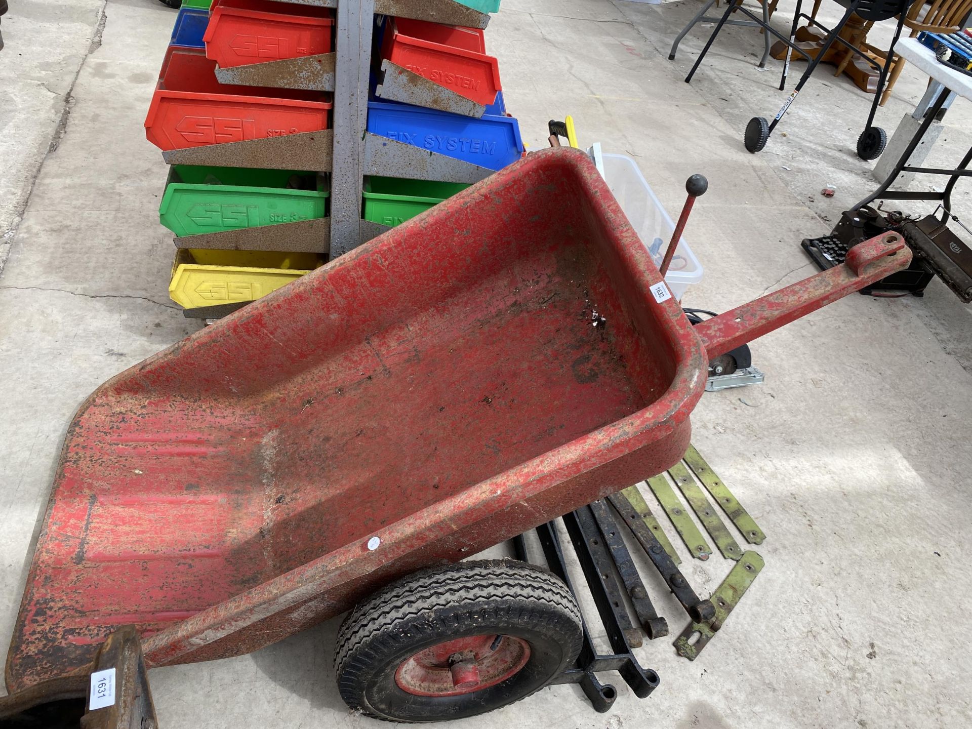 A METAL TWO WHEELED RIDE ON MOWER TRAILER