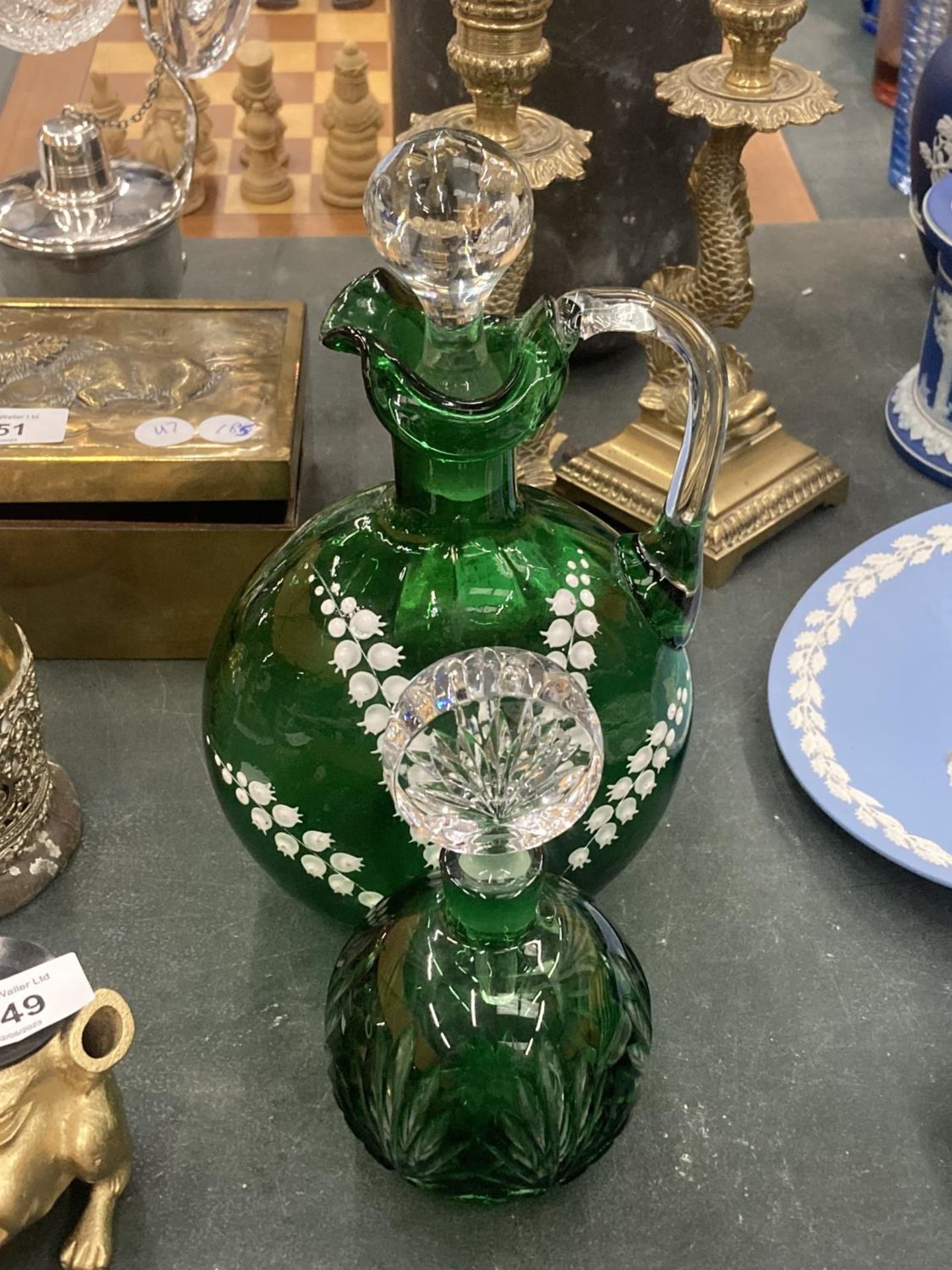 A VICTORIAN GREEN GLASS JUG WITH STOPPER WITH HAND PAINTED DECORATION PLUS A SCENT BOTTLE WITH