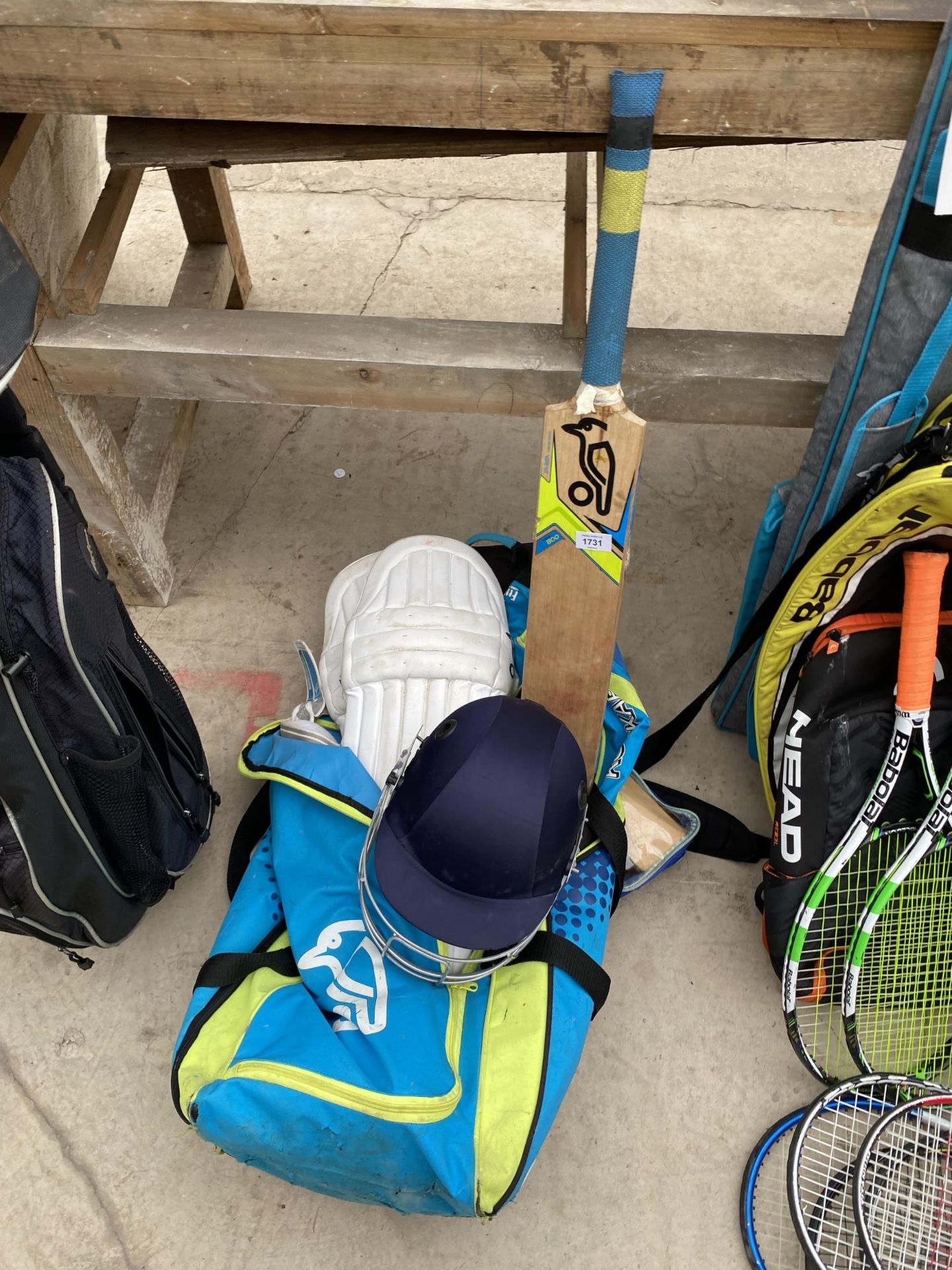 AN ASSORTMENT OF CRICKET EQUIPMENT TO INCLUDE A BAG, A BAT AND A HELMET ETC