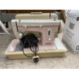 AN ELECTRIC PANORAMIC SEWING MACHINE WITH CARRY CASE AND FOOT PEDAL