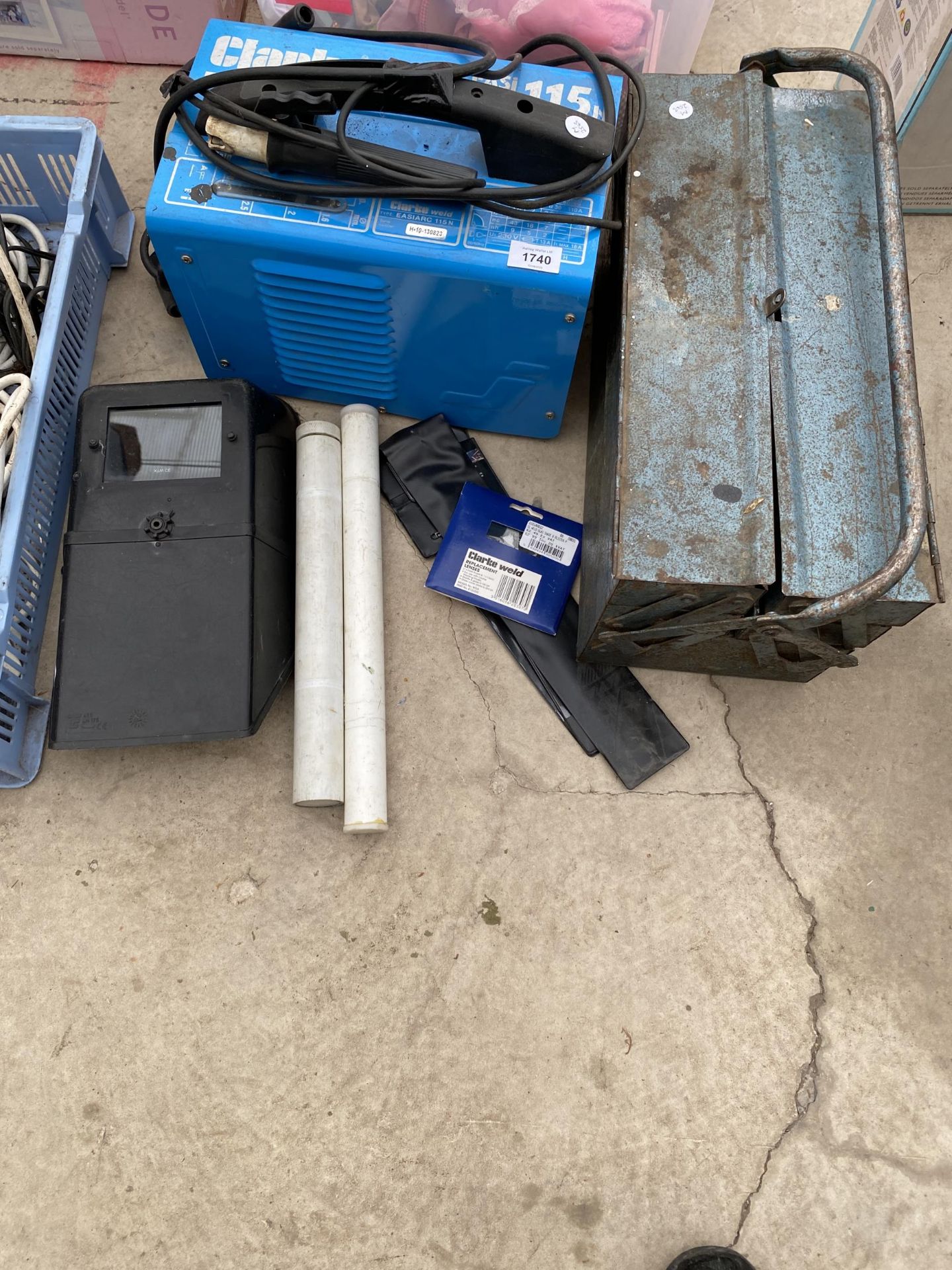 A CLARKE ARC WLEDER, WELDING MASK, AND A METAL TOOL BOX WITH AN ASSORTMENT OF HAND TOOLS ETC