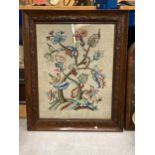 AN EARLY 20TH CENTURY NEEDLEWORK OF FLOWERS, 53CM X 42CM, FRAMED AND GLAZED