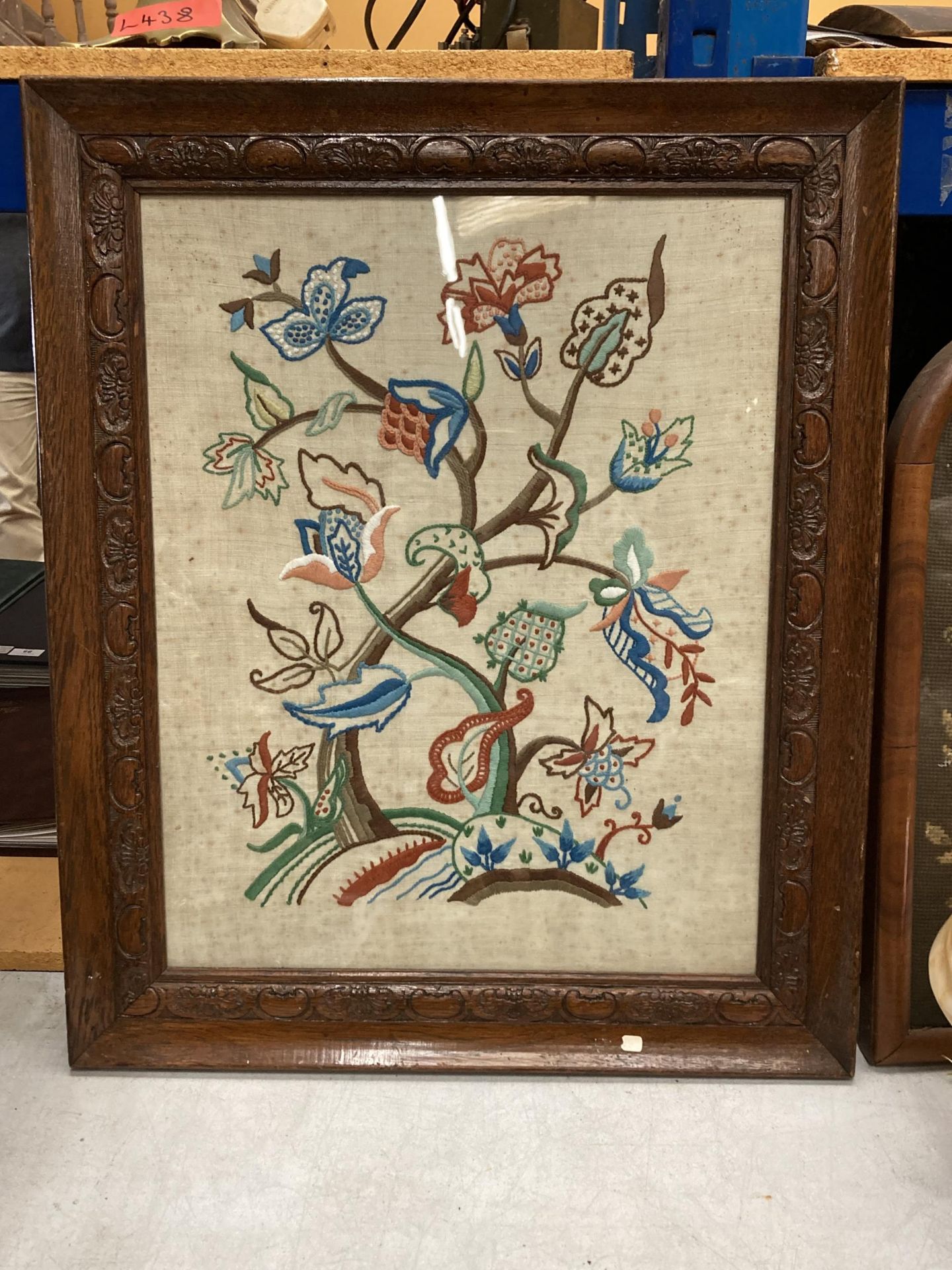 AN EARLY 20TH CENTURY NEEDLEWORK OF FLOWERS, 53CM X 42CM, FRAMED AND GLAZED