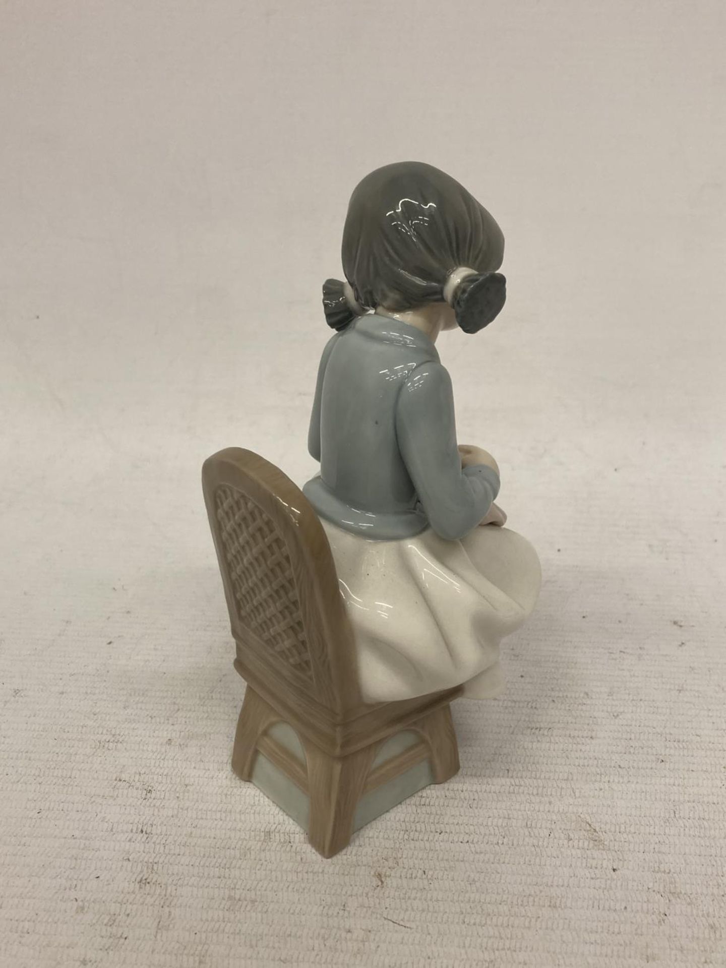 A NAO FIGURINE OF A GIRL SEWING - Image 2 of 3