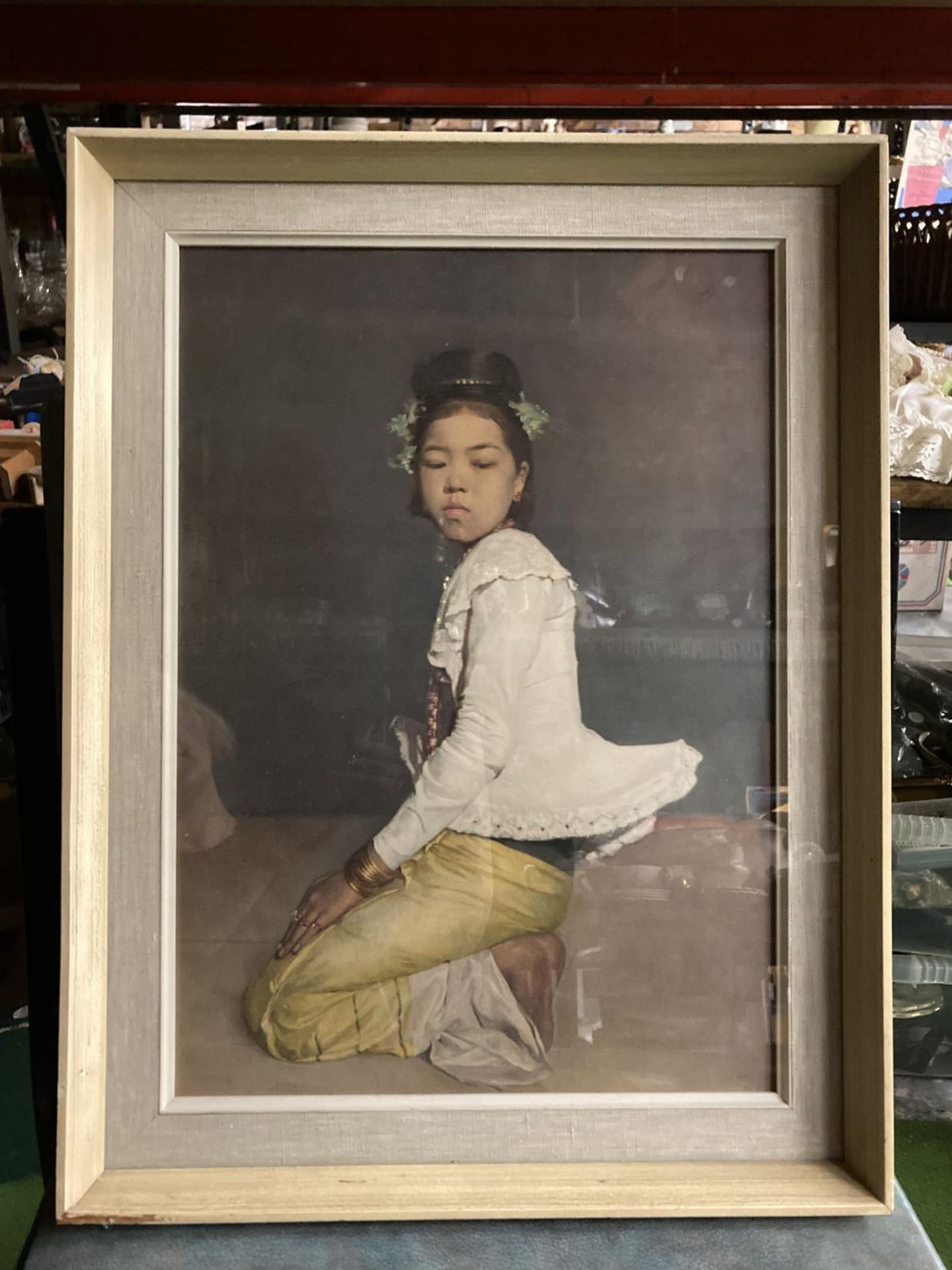 A FRAMED PRINT OF AN ASIAN GIRL BY SIR GERALD KELLY