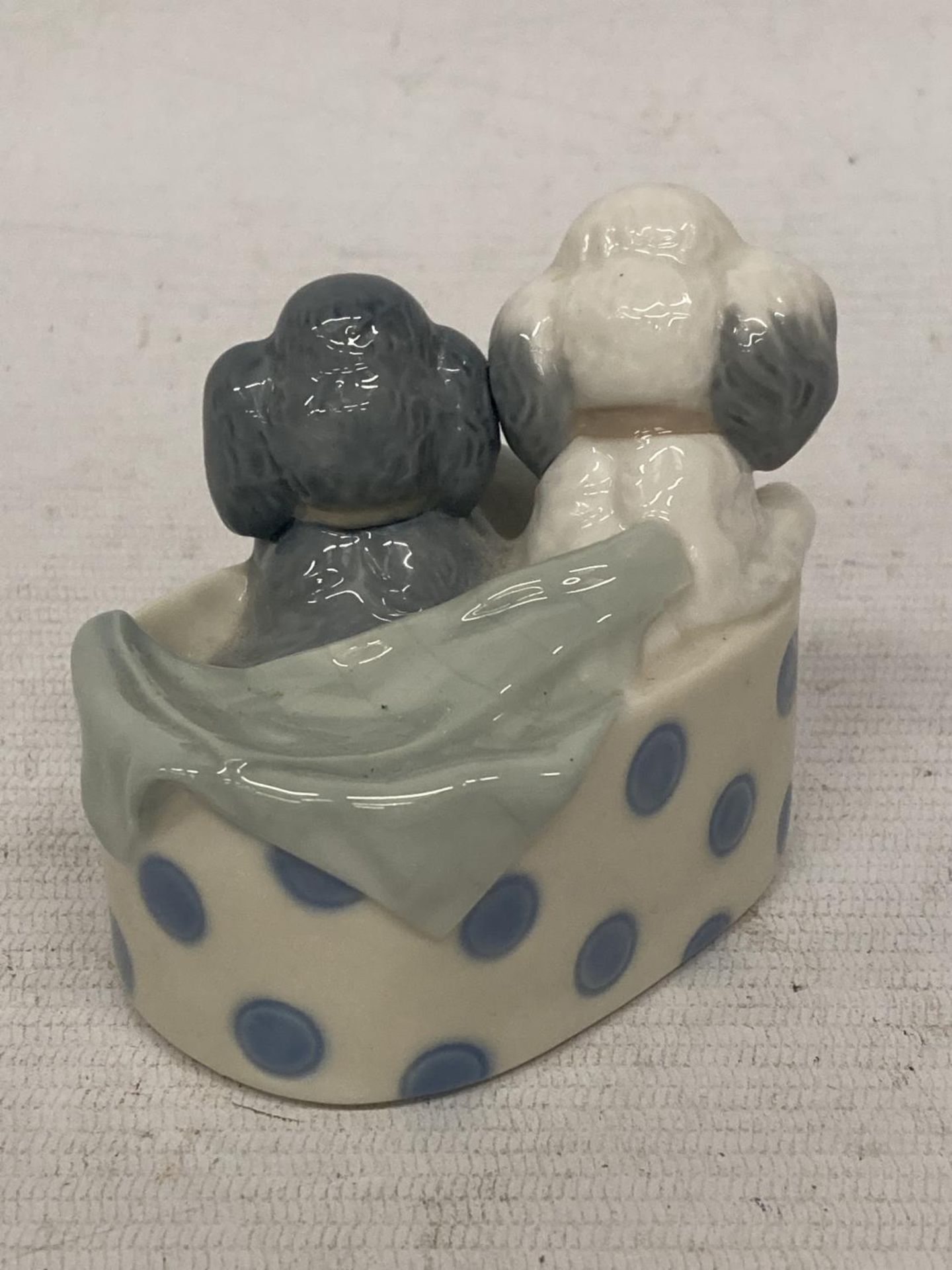 A NAO FIGURE OF TWO DOGS IN A BASKET - Image 2 of 3