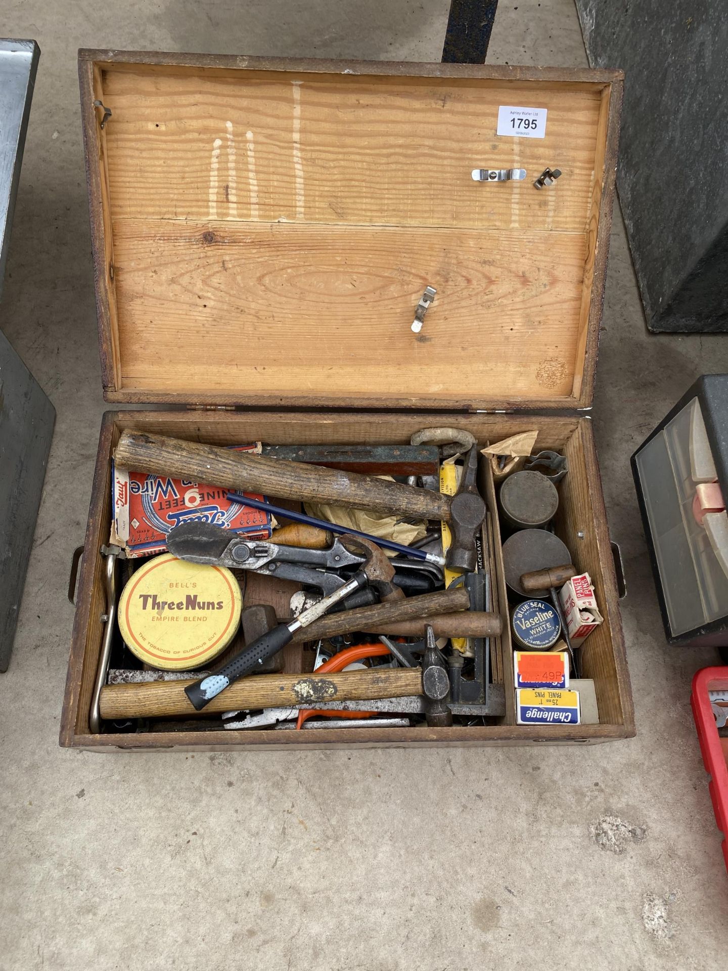 A WOODEN CHEST CONTAINING AN ASSORTMENT OF TOOLS AND HARDWARE TO INCLUDE HAMMERS AND TIN SNIPS ETC