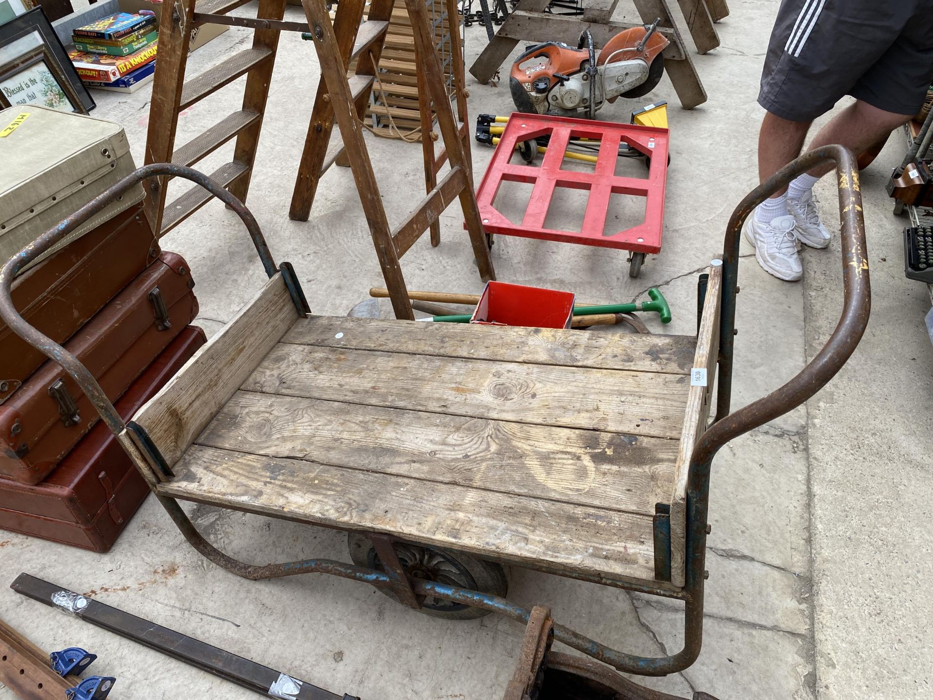 A TWO WHEELED METAL AND WOODEN PLANT MARKET GARDENERS TROLLEY