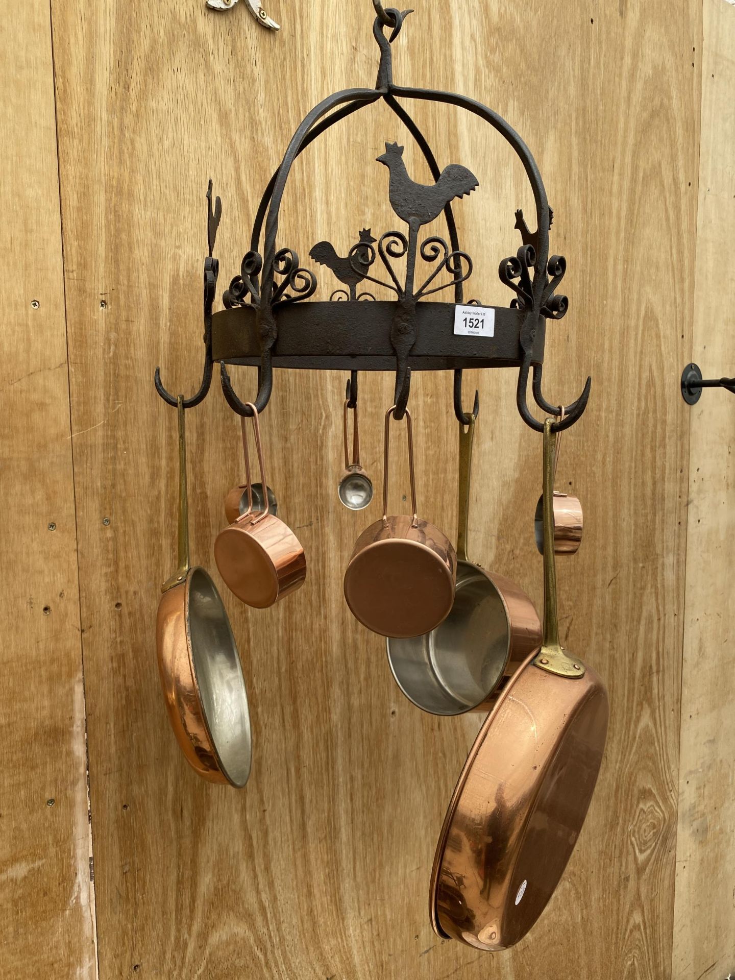 A VINTAGE BLACKSMITH MADE WROUGHT IRON POT HANGER WITH COPPER PANS AND SAUCE POTS (WALL BRACKET