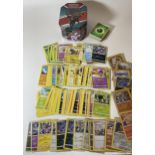 AN UMBREON TIN OF POKEMON TRADING CARDS, HOLOS ETC