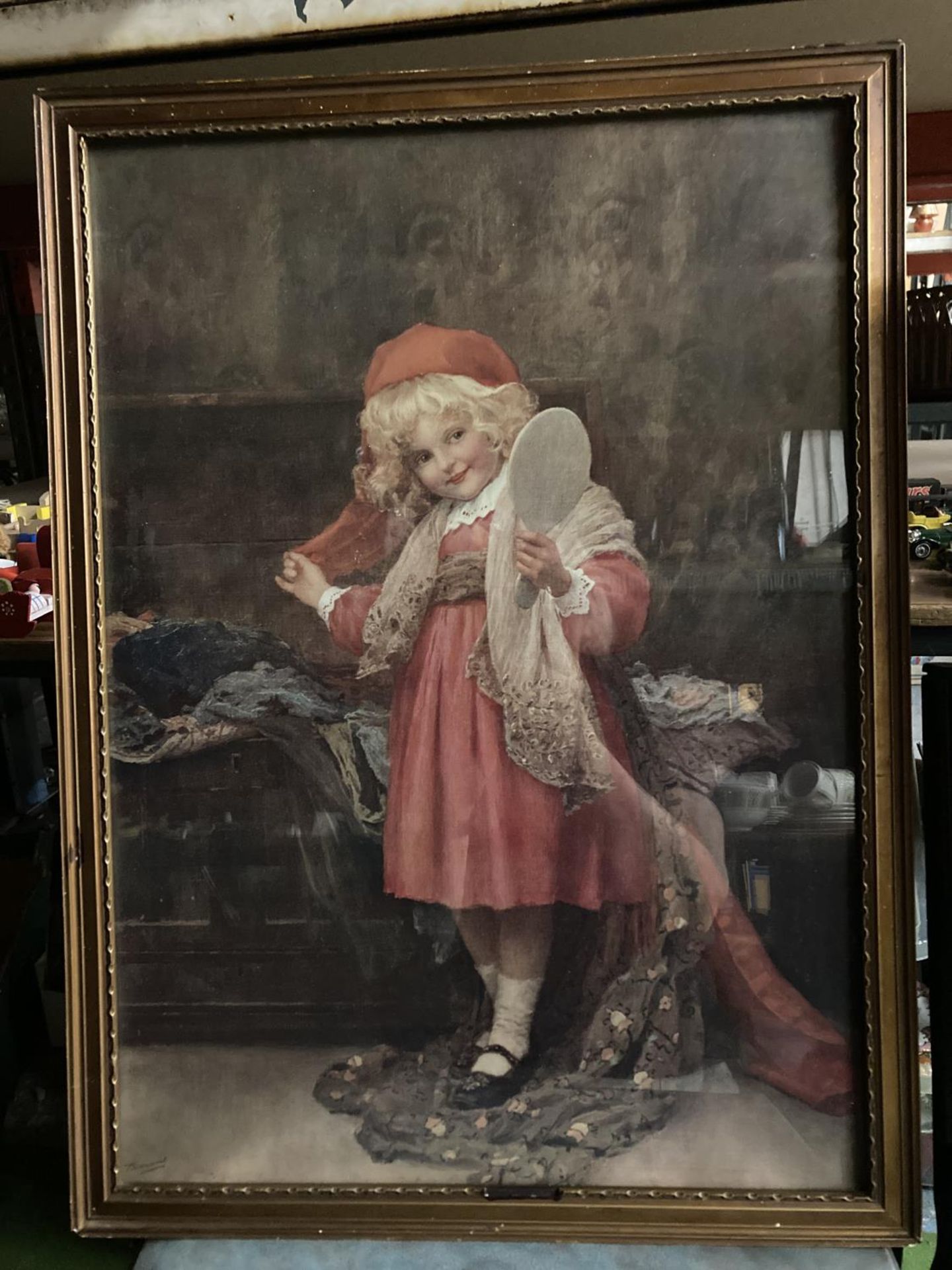 A PERCY TARRANT FRAMED EDWARDIAN PRINT OF A GIRL IN RED HOLDING A MIRROR