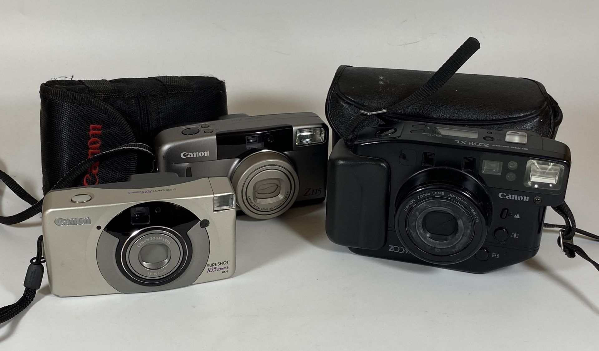 THREE CANON CAMERAS - CANON SURE SHOT 105 ZOOM S WITH 105MM LENS, CANON Z115 WITH 115MM LENS AND A