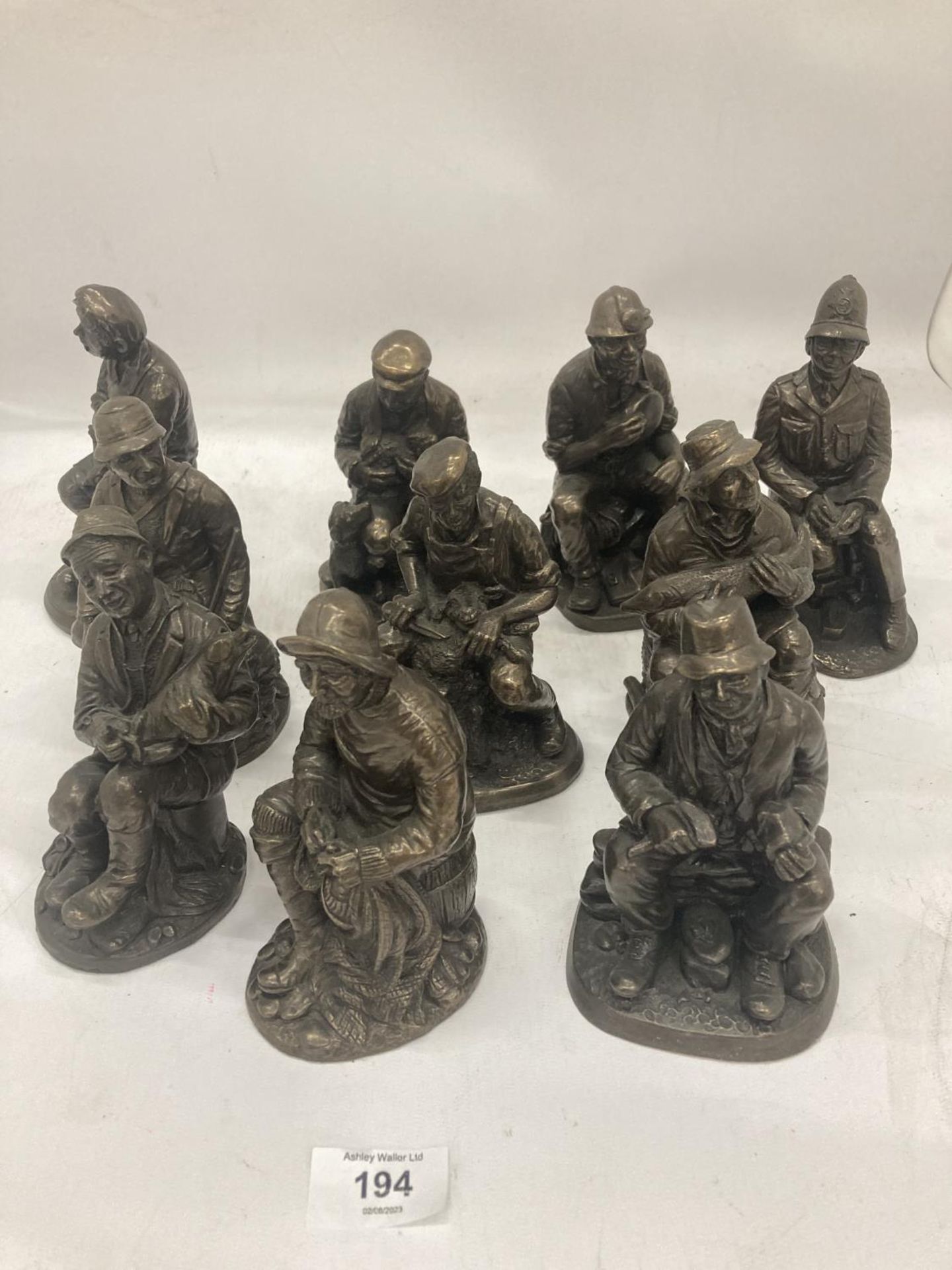 A COLLECTION OF VINTAGE STYLE FIGURES TO INCLUDE A BLACKSMITH, FISHERMAN, MINER, FARMER, ETC - 10 IN