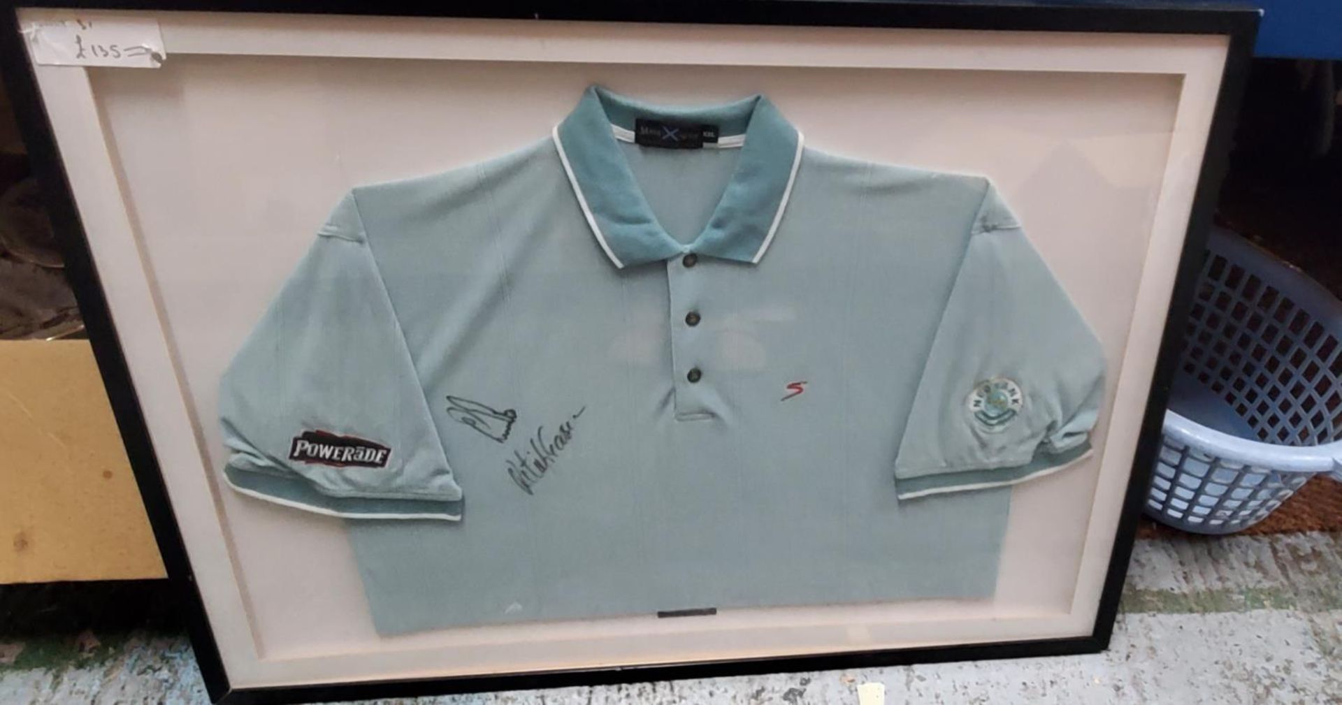 A SIGNED FRAMED SHIRT OF GOLFER RETEIF GOOSEN, WINNER OF US OPENS 72CM X 96CM