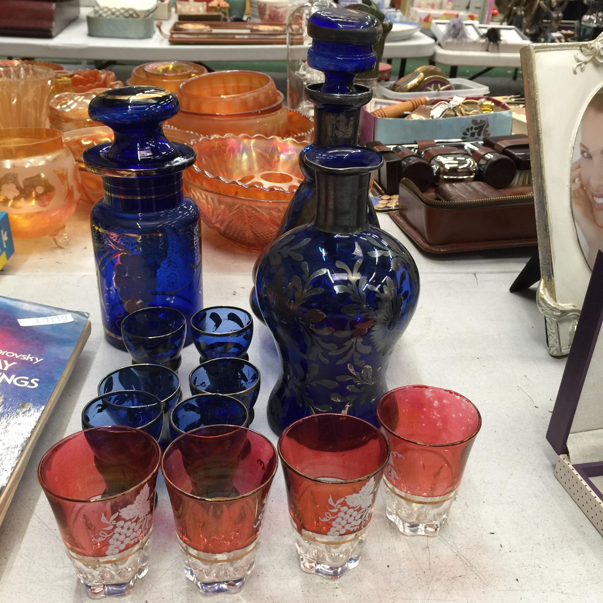 A VINTAGE BLUE GLASS WITH GILT DECORATION DECANTER, STORAGE JAR, VASE AND GLASSES PLUS FOUR