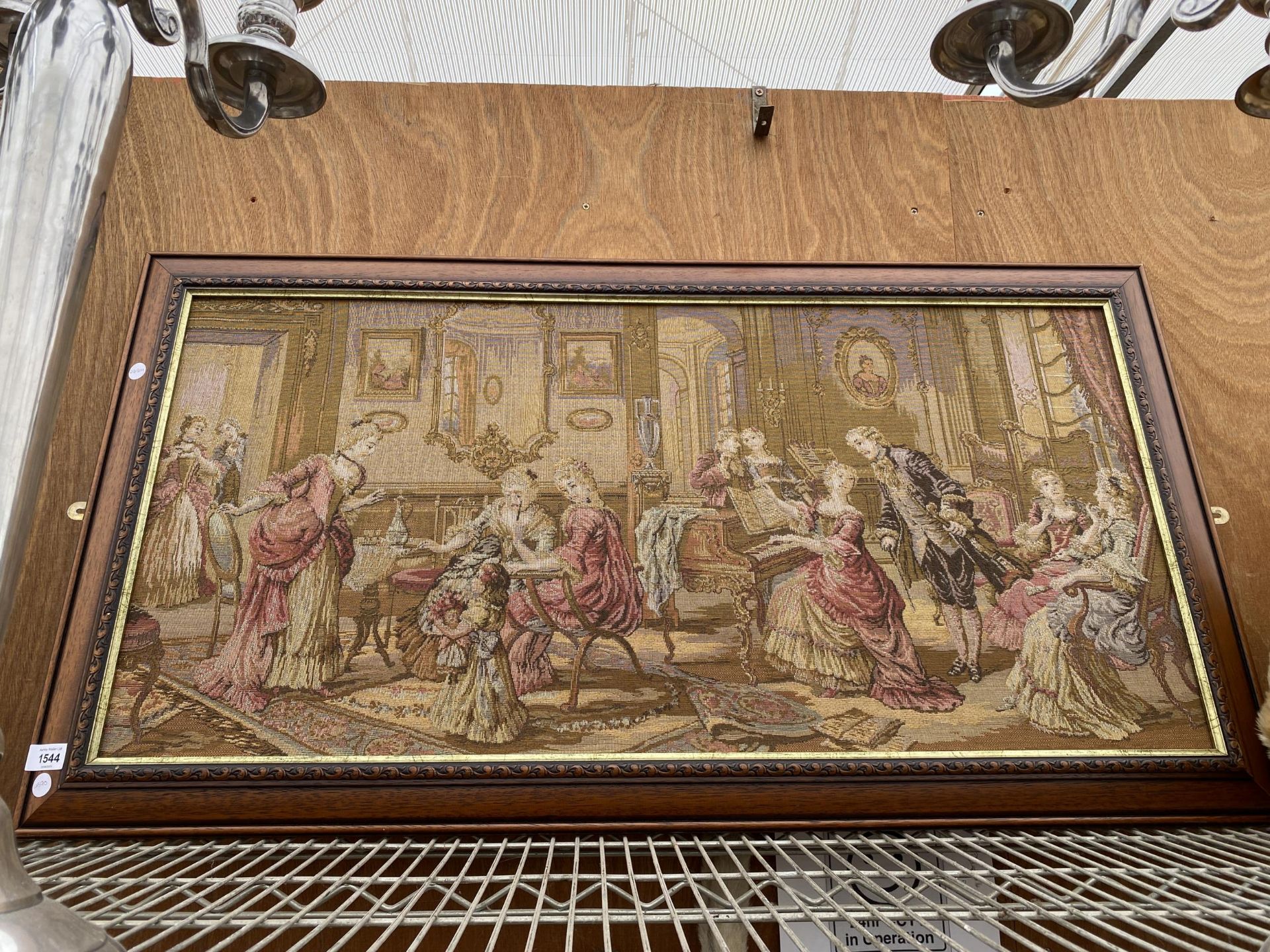 A FRAMED TAPESTRY OF A MANOR HOUSE SCENE