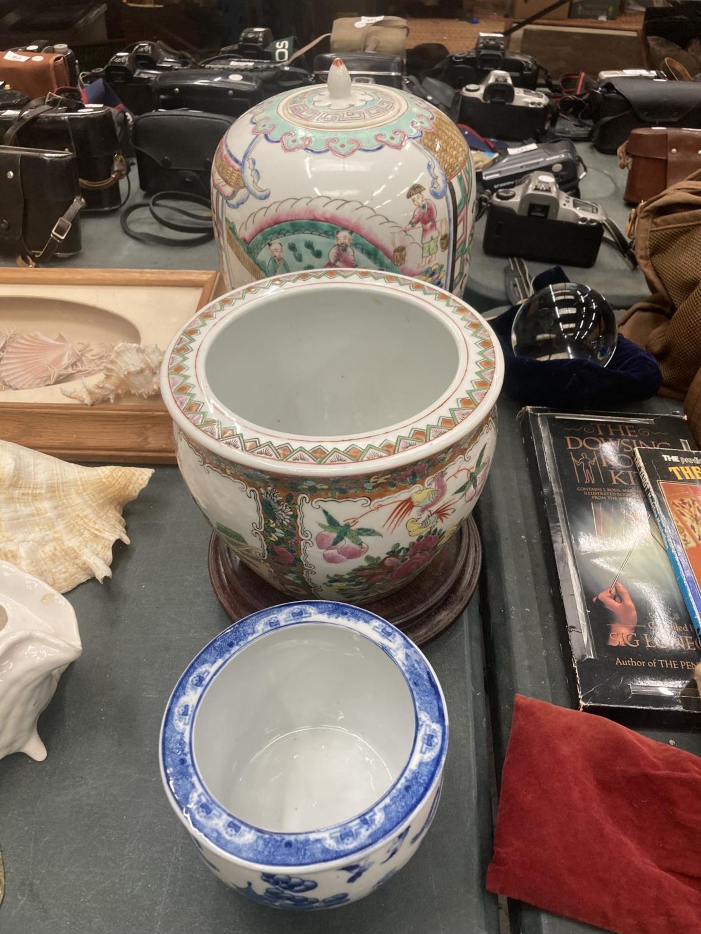 A LARGE ORIENTAL JAR WITH LID, A LARGE PLANTER WITH WOODEN STAND AND A SMALLER BLUE AND WHITE