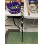 A WOODEN TWISTED SNAKE WALKING STICK WITH INLAID MOTHER OF PEARL