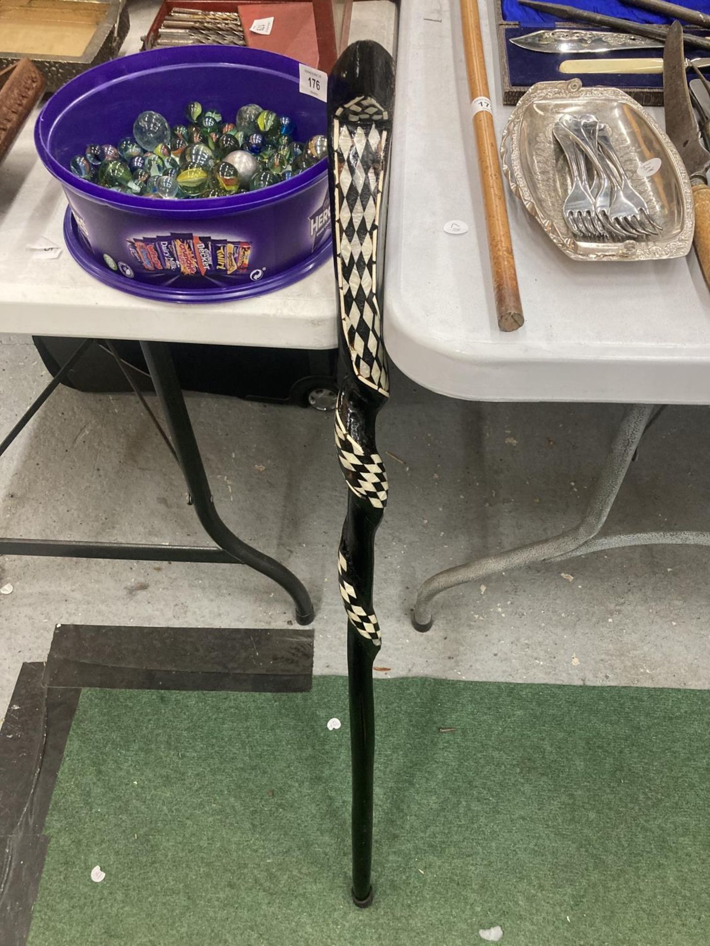 A WOODEN TWISTED SNAKE WALKING STICK WITH INLAID MOTHER OF PEARL