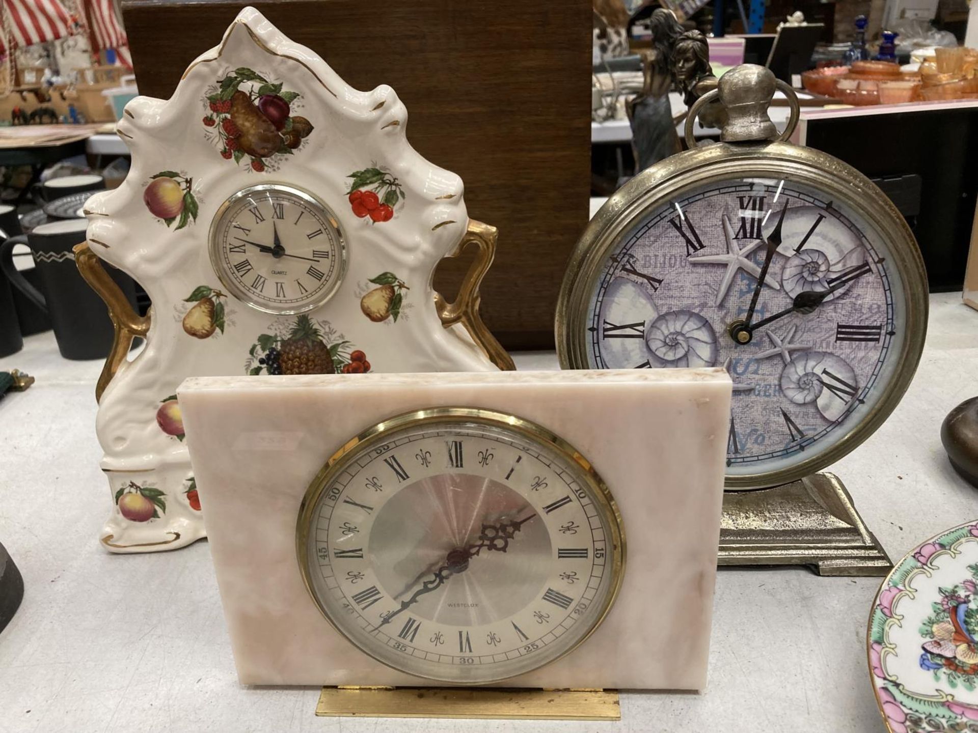 A BATTERY OPERATED CLOCK IN THE FORM OF A POCKET WATCH, WESTCLOX MANTLE CLOCK FAUX MARBLE AND A