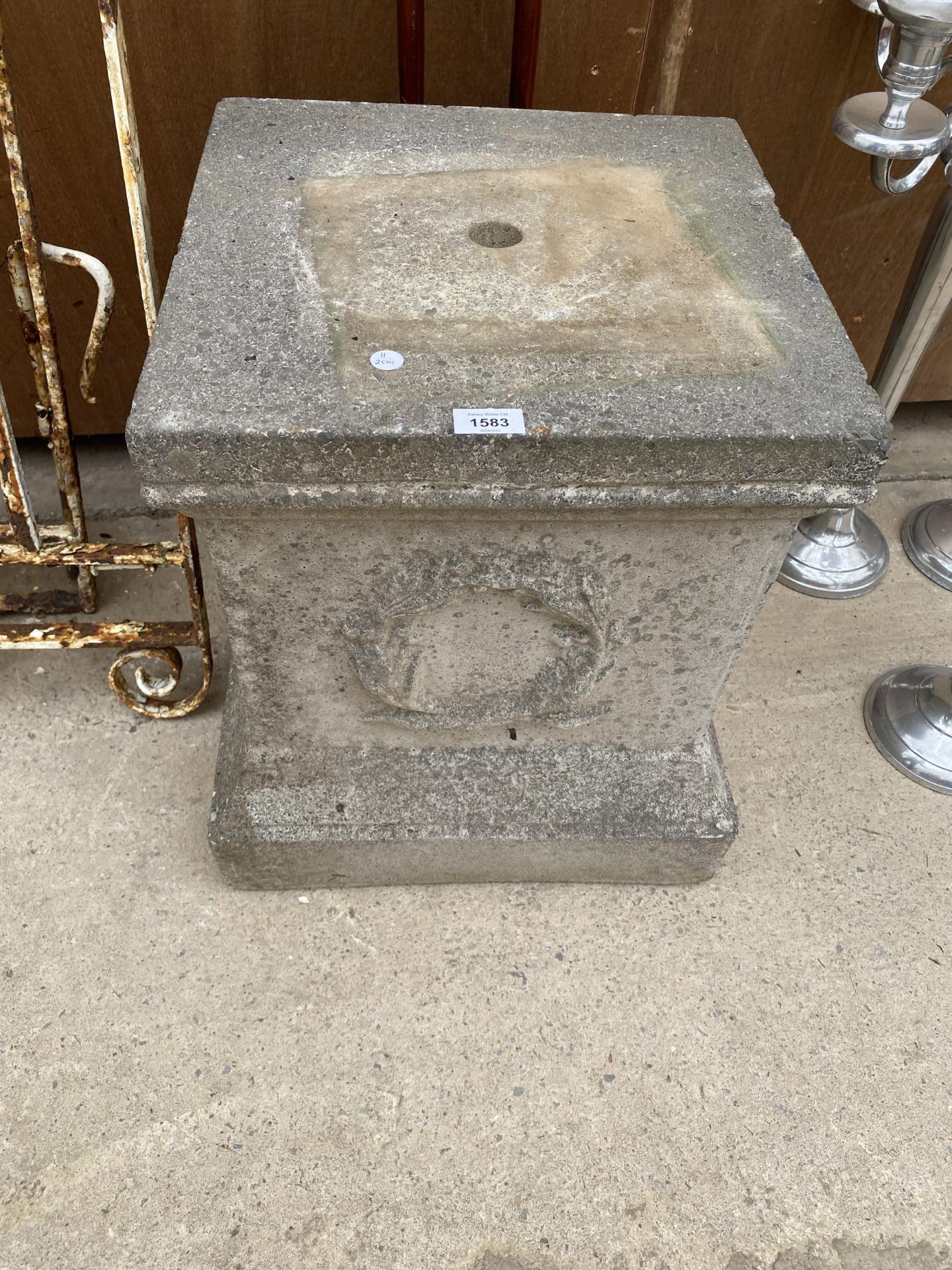 A SQUARE RECONSTITUTED STONE PEDESTAL BASE