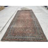 AN ANTIQUE, BELIEVED PERSIAN RUG 211 CM X 480 CM