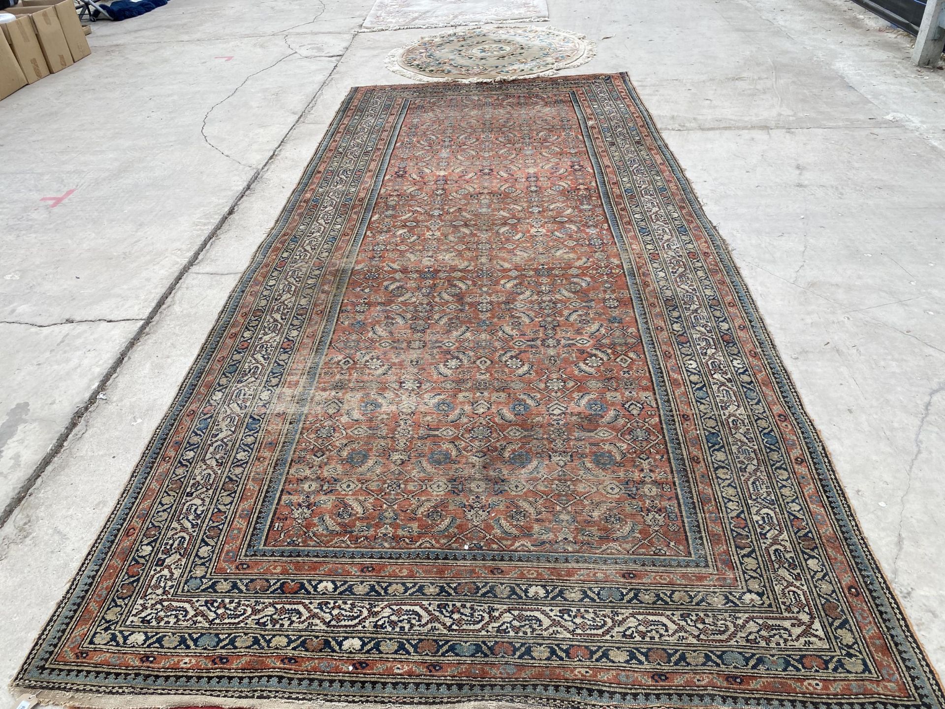 AN ANTIQUE, BELIEVED PERSIAN RUG 211 CM X 480 CM